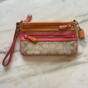 cute coach wristlet with pink and orange details!